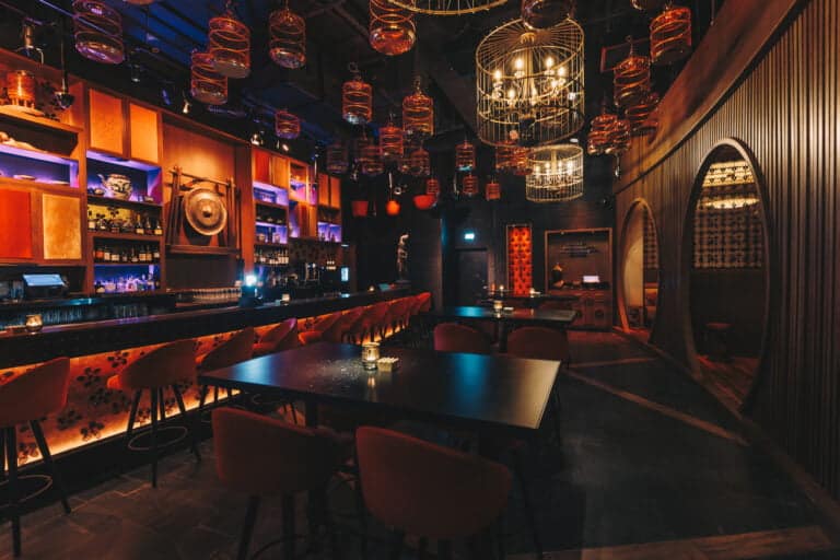 Bar with warm back-bar lighting and dark timber at Asia Asia Yas Bay, Abu Dhabi