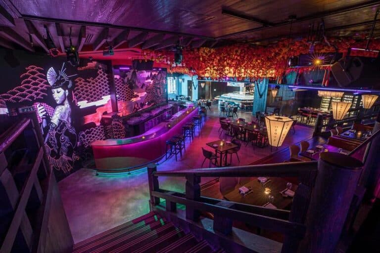 Dining room with purple and blue lighting and character artwork at KOYO, InterContinental Dubai Marina