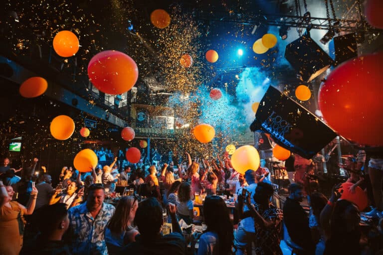 Crowd celebrating under balloons, confetti and stage lighting at Lock Stock & Barrel Yas Bay, Abu Dhabi