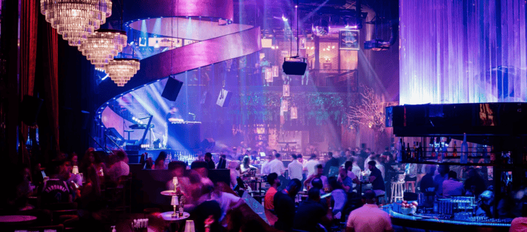 Packed venue with chandeliers, moving-head beams and purple lighting at Bla Bla Beach Club, JBR